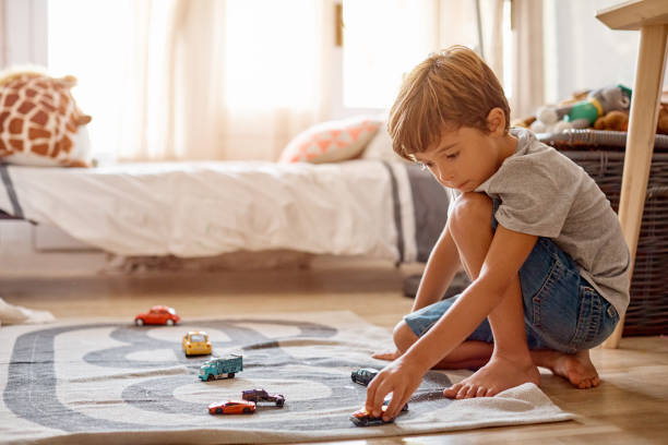 Shot of a little boy playing with his toys at home